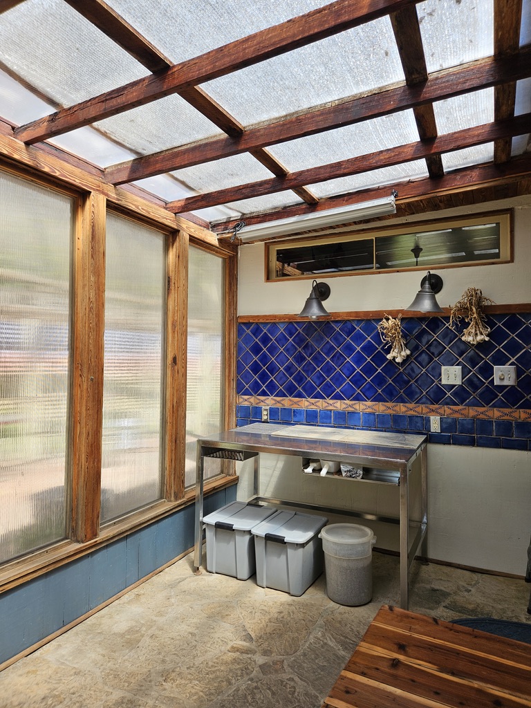 Solarium roof with shade cloth for summer, poly inserts in the large windows for winter.